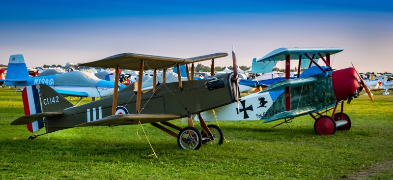 outdoors, old, multi colored, grass, plane, food and drink, day, land, green color, transportation, landscape, group of people, aeroplane, military, food