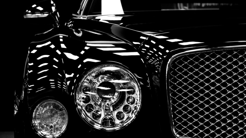 headlight, retro styled, silver, glass - material, land vehicle, Bentley, focus on foreground, 4K, close-up, analog, indoors, vintage car, pattern, no people