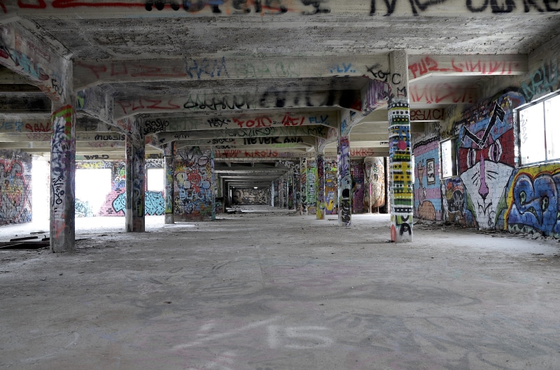 creativity, text, building, built structure, full, indoors, wall - building feature, concrete, streetart, factory, warehouse, flooring, direction, abandoned