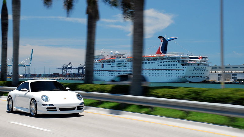 mode of transportation, day, land vehicle, tree, white, sky, car, motion, 1080P, travel, plant, black, architecture, Porsche 911, city, on the move, trailer