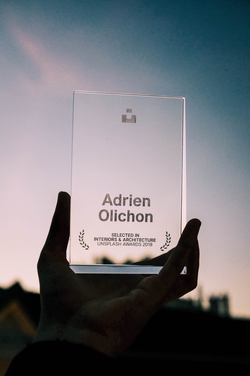finger, cell phone, human finger, billboard, personal perspective, person, outdoors, 5K, diamond, text, trophy, logo, symbol, close-up, adrien, real people