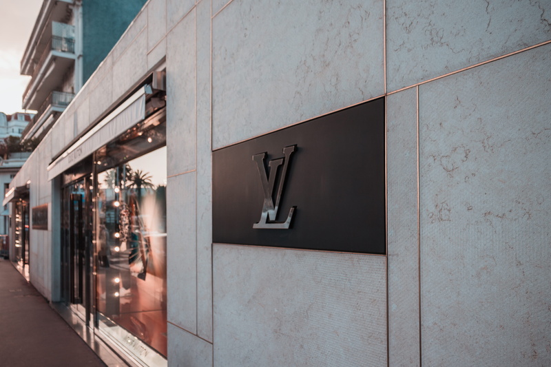 no people, text, footpath, vuitton, modern, store, architecture, signage, day, building exterior, entrance, human representation, outdoors, building, sign