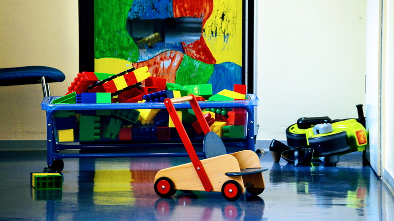 toys, cleaning equipment, daycare, day, architecture, equipment, flooring, table, focus on foreground, messy, toy car, multi colored, indoors, car, play