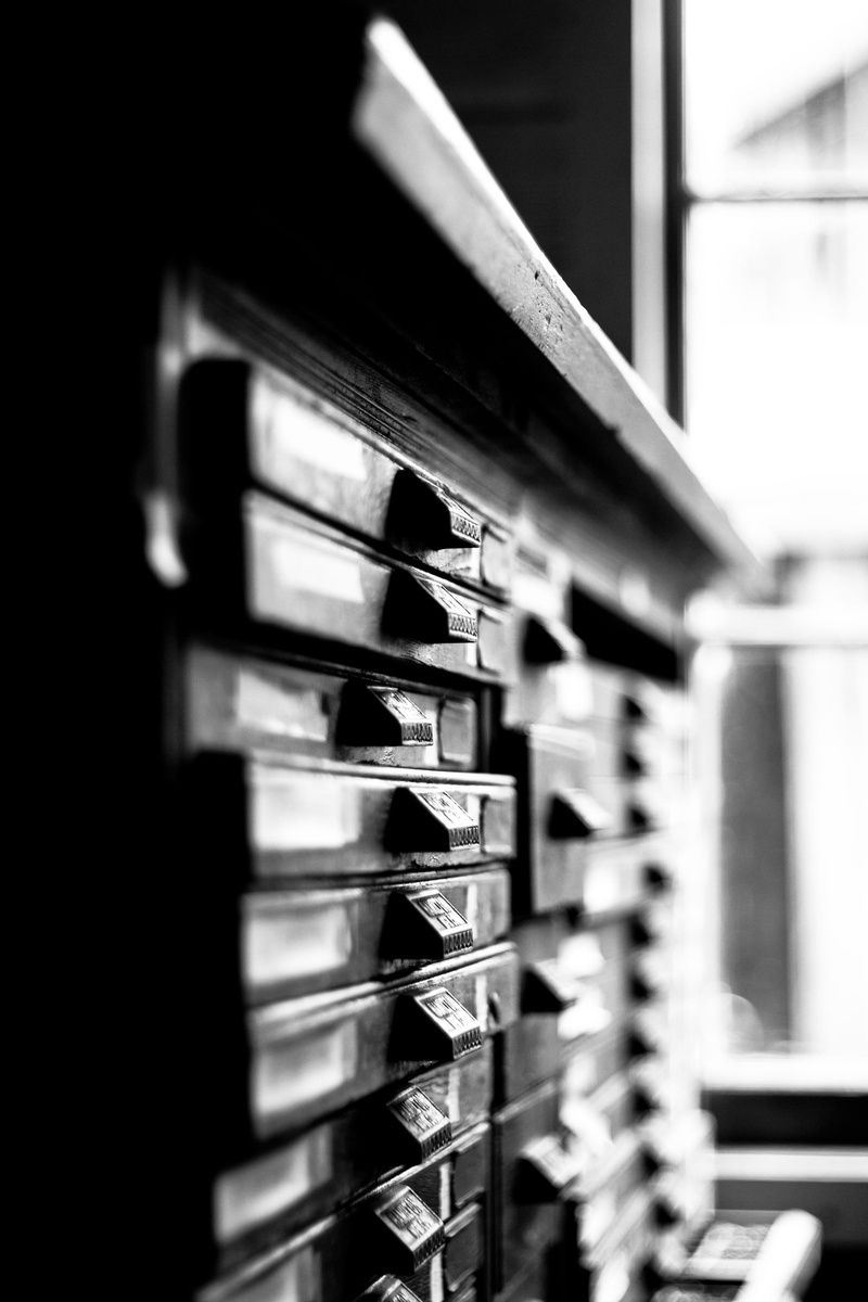architecture, letterpress, selective focus, cabinet, equipment, built structure, metal, focus on foreground, still life, industry, lead type, day, domestic room