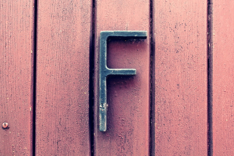 wall - building feature, f, backgrounds, outdoors, 2K, metal, door, surface, tool, day, wooden, closed, entrance, black, pattern, close-up, letter, security