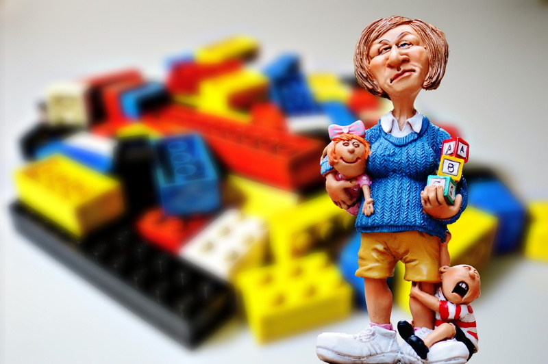 figurine, robot, Lego, nanny, selective focus, focus on foreground, 2K, child, Educator, smiling, childrens room, happiness, enjoyment, positive emotion