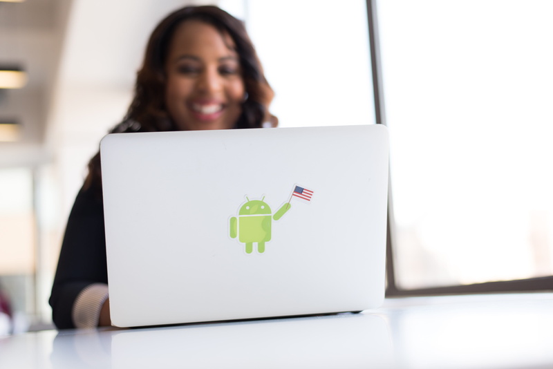 focus on foreground, desk, portrait, emotion, american flag, female, holding, smiling, office, women, coder, looking, smile, developer, indoors, 5K, woman