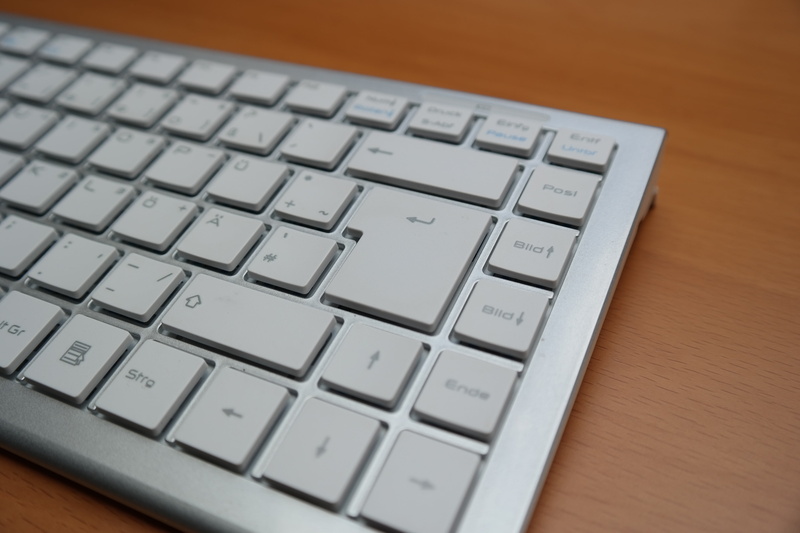 return button, input, computer key, table, font, silver colored, enter button, tap, computer keyboard, surface, no people, communication, wooden, connection