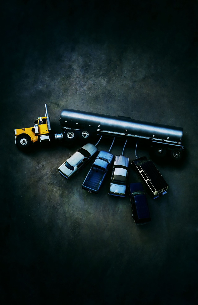 studio shot, table, high angle view, humor, black background, color, transportation, still life, gun, vehicle, technology, no people, toy, communication