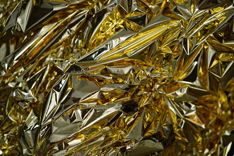 first aid, gold colored, 8K, focus on foreground, leaf, rescue film, gold, slide, metallized plastic film, silver foil, jewelry, high angle view, protective film