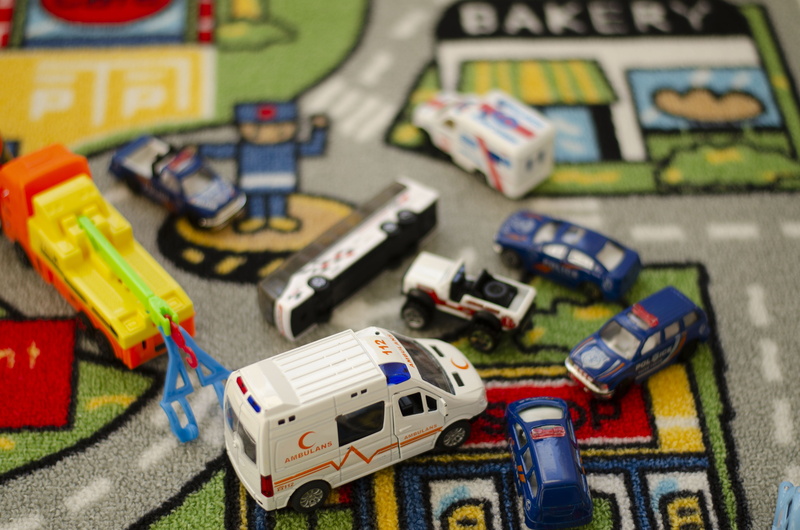 medical, large group of objects, stack, indoors, game, leisure games, day, selective focus, high angle view, toy, ambulance, leisure activity, focus on foreground
