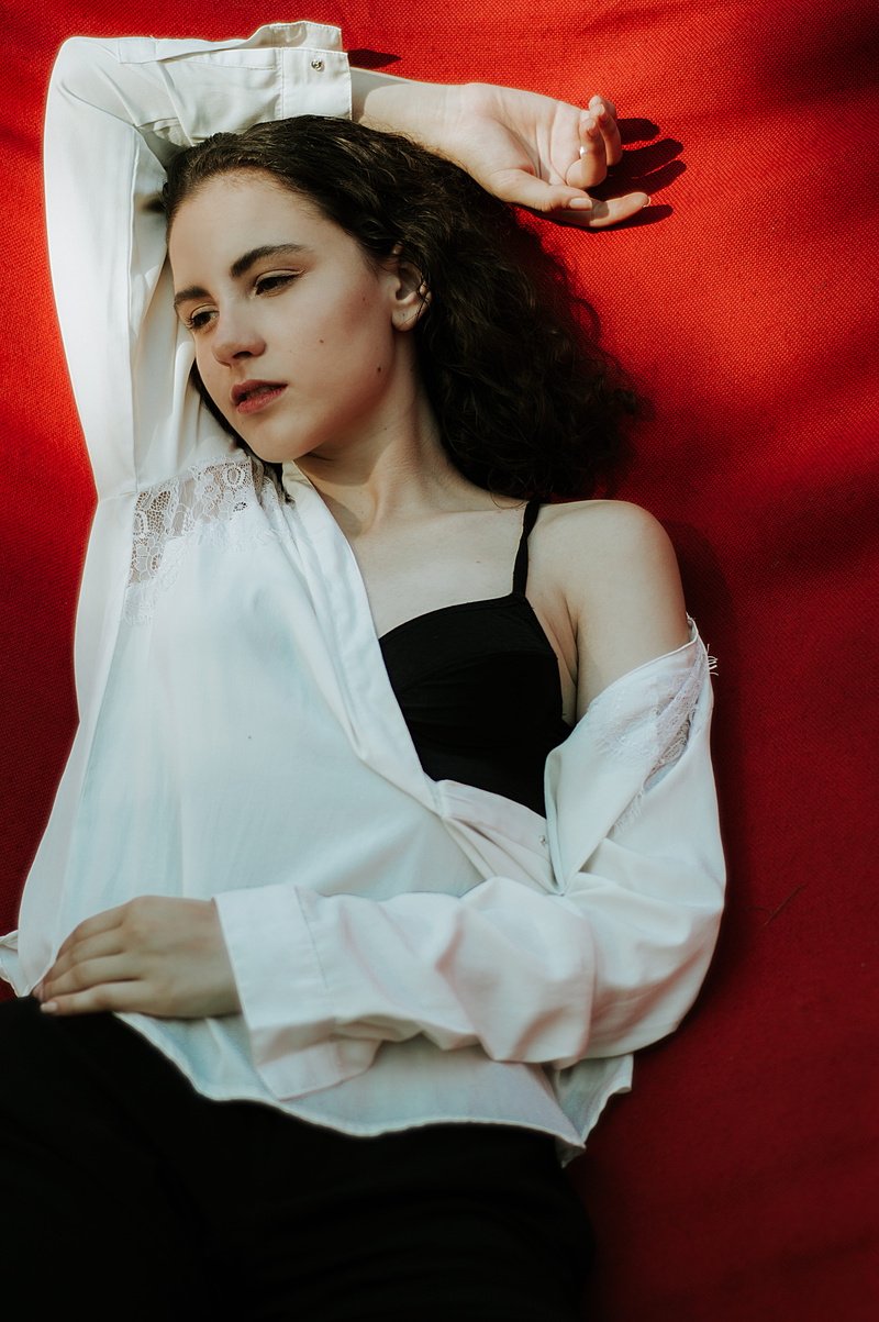 woman, hairstyle, 5K, apparel, wearing, plant, person, lifestyles, furniture, beautiful woman, red, human arm, female, arms raised, one person, young women