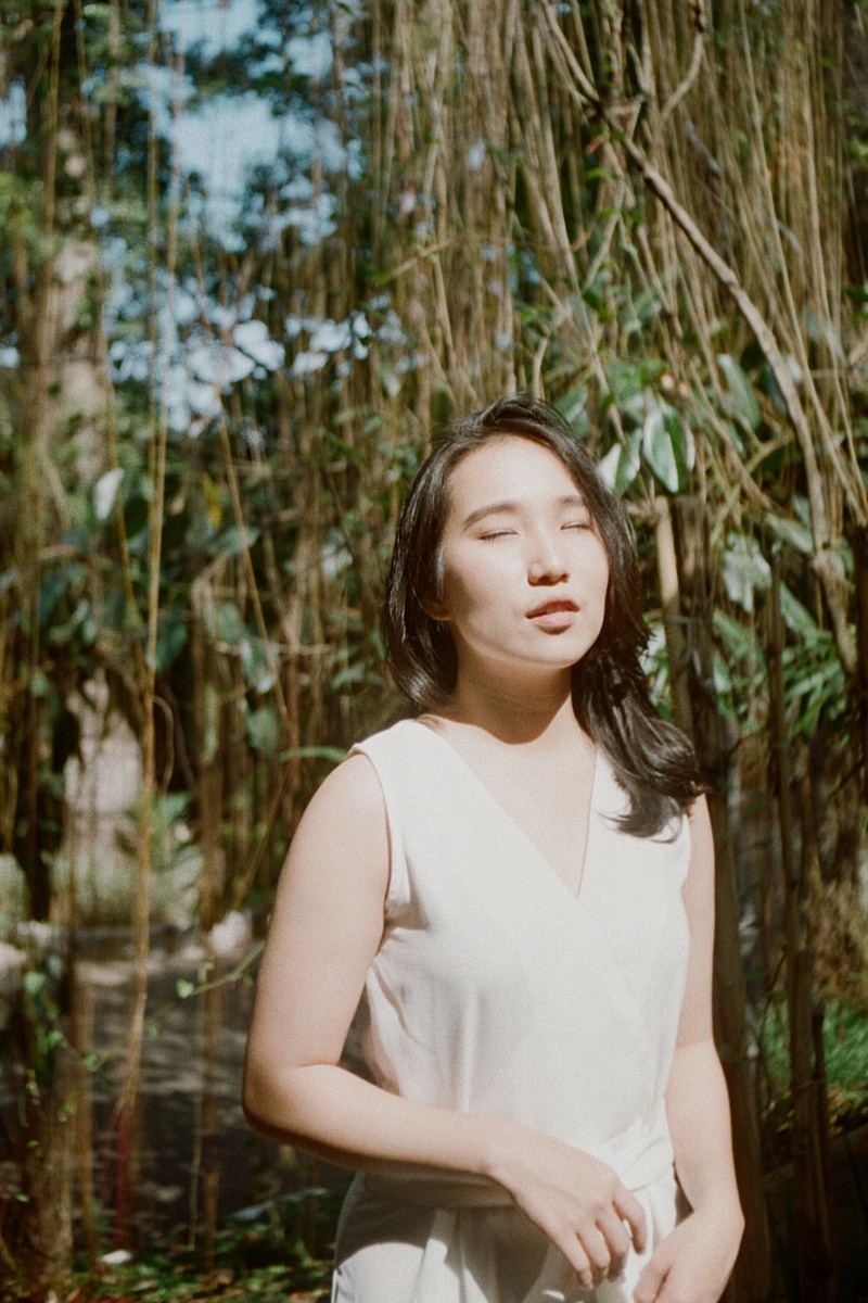 apparel, beauty, clothing, forest, waist up, blossom, finger, front view, contemplation, one person, undershirt, outdoors, banister, nature, real people