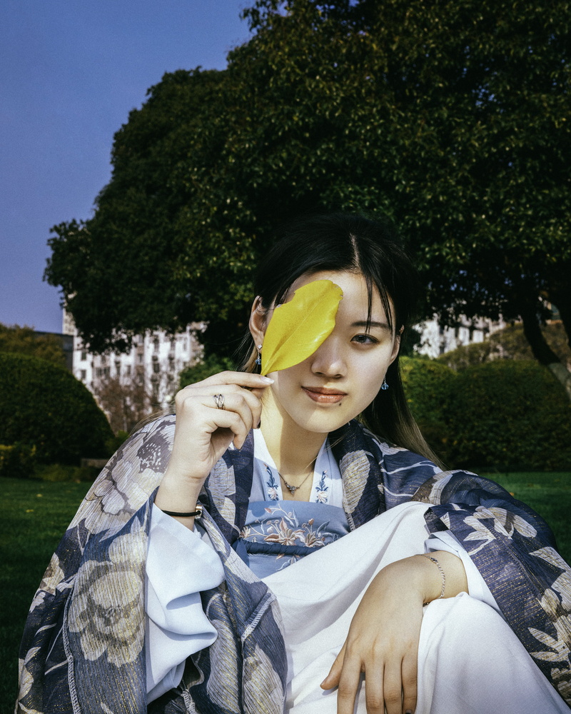 real people, day, evening dress, women, costume, finger, young adult, hairstyle, lifestyles, grass, kimono, sunglasses, looking, three quarter length, flagstone