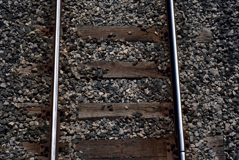 wood - material, pattern, narrow, high angle view, day, outdoors, rail transportation, gravel, stones, railway, close-up, background, train, metal, old