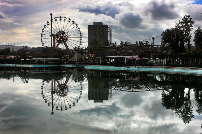 cloud - sky, no people, travel destinations, building exterior, reflection, landscape, day, 5K, built structure, sky, amusement park ride, pool, ferris wheel
