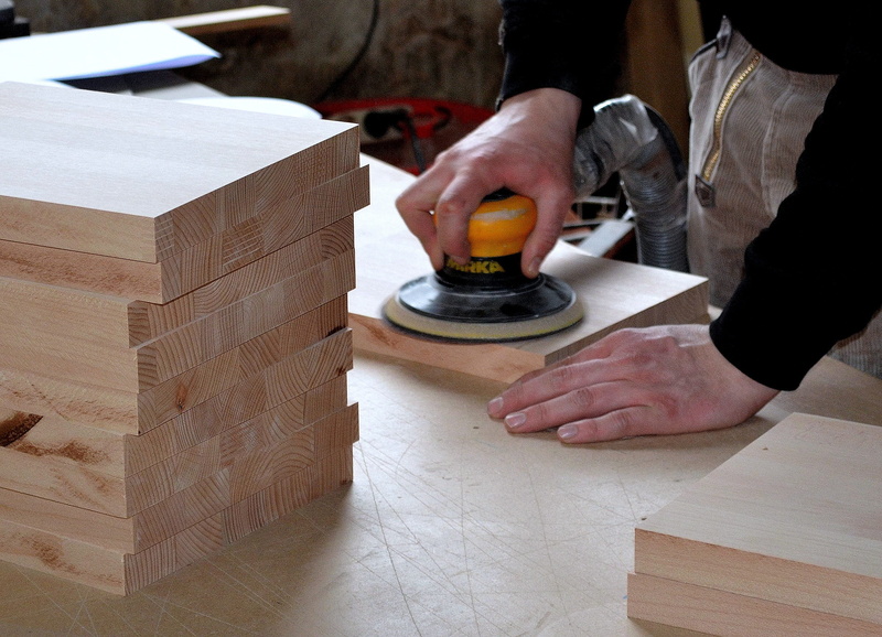 one person, wood - material, workers, human body part, real people, table, craft, woodworking, hand, wood, occupation, workshop, room, art and craft, tool