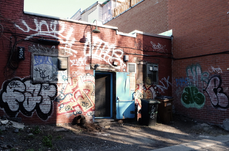 brick wall, front, trash, art and craft, building exterior, architecture, outdoors, text, representation, mural, alley, spray paint, back door, garbage
