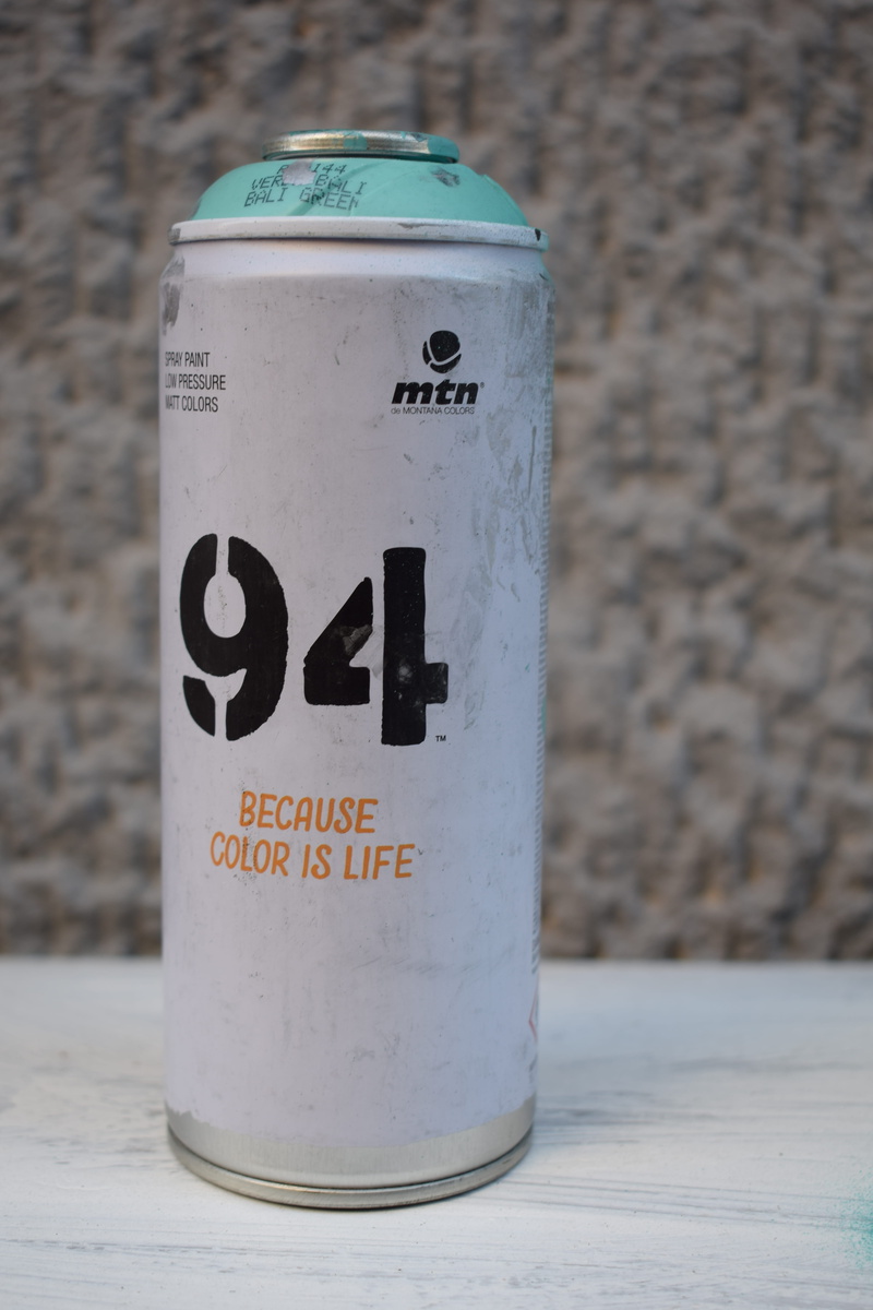 label, wall - building feature, message, container, spray can, shaker, word, cylinder, script, spandex, text, drink, number, communication, can, western script