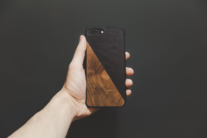 case, indoors, 5K, phone, holding, hand, connection, black, brown, person, body part, iphone, personal perspective, smart phone, communication, wooden