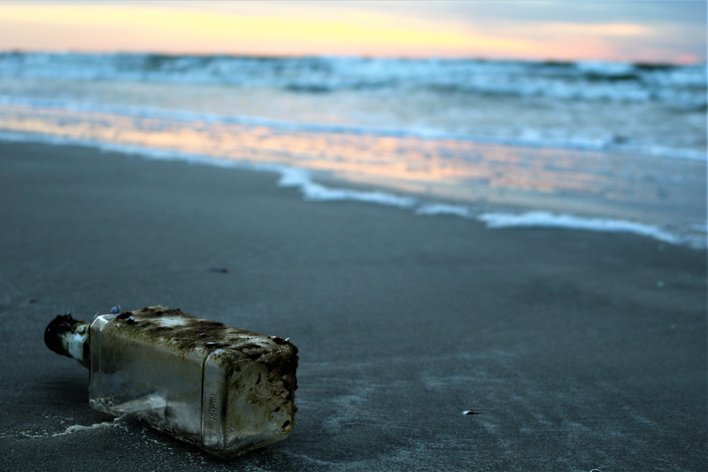 island, close-up, tranquility, seashore, travel, ocean, no people, land, bottle, outdoors, landscape, near, wave, beauty in nature, pollution, sky, beach
