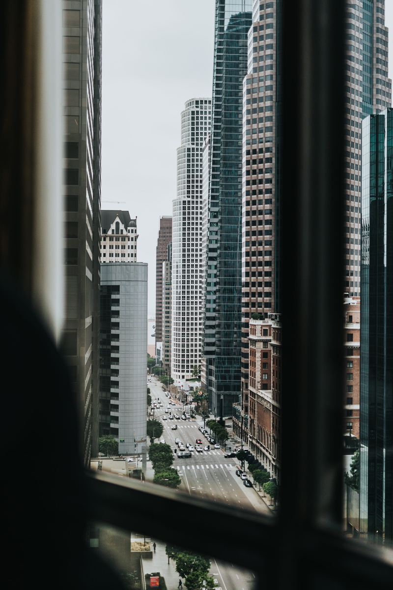 rise, architecture, city, high, modern, motor vehicle, financial district, tower, teal, outdoors, car, la, transportation, avenue, land vehicle, day, buildings