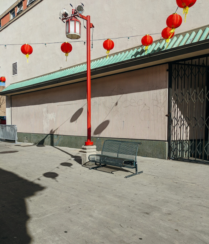 no people, outdoors, absence, pavement, chinatown, light, urban, day, pedestal, beside, communication, bench, post, gatw, lighting equipment, text, shadow