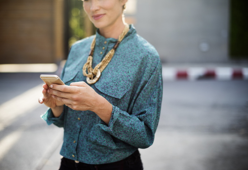 shirt, outdoors, texting, portable information device, telephone, using Phone, iphone, teal, real people, mobile Phone, women, dress, adult, casual Clothing