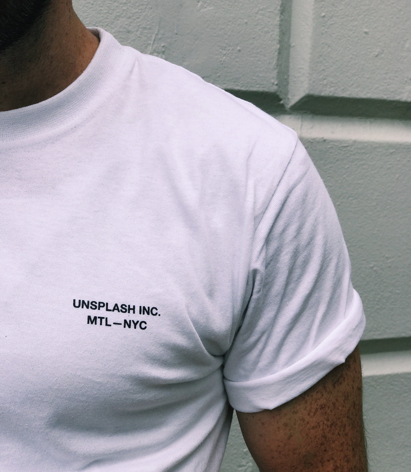 midsection, text, crew, wall, one person, leisure activity, communication, white color, outdoors, wall - building feature, neck, short, front view, shirt