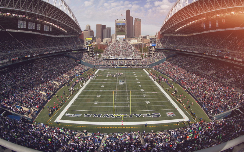 skyscraper, outdoors, crowd, seahawks, sport, day, travel destinations, playing field, built structure, sports, football, sky, spectator, group of people