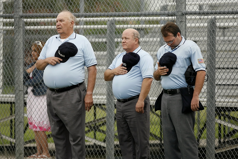 stomach, sports officials, sport, group of people, three quarter length, hats, chainlink fence, american, three, fence, 2K, senior adult, league, holding