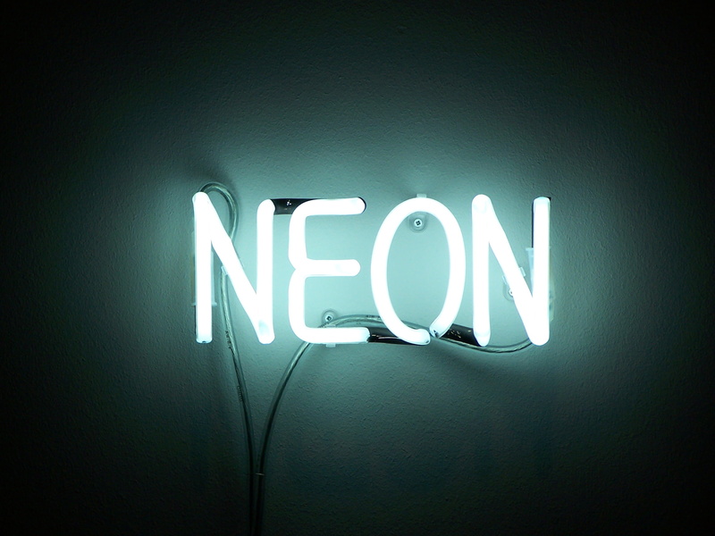 indoors, wall - building feature, no people, neon, single word, sign, glowing, backgrounds, year, blue, led, lighting equipment, symbol, studio shot, vignette