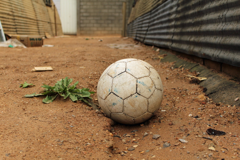 camp, grass, sport, refugee, 5K, nature, focus on foreground, damaged, ball, messy, playing field, no people, soccer, soccer field, field, dirt, close-up