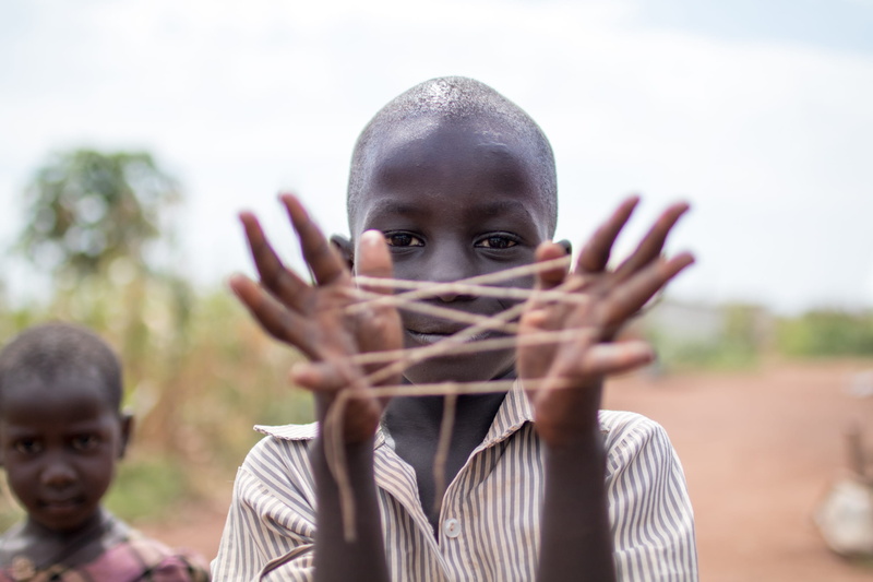 emotion, 1080P, males, boy, tied, smile, looking at camera, thread, boy playing, fun, one person, child, playing, kampala, childhood, string game, boys