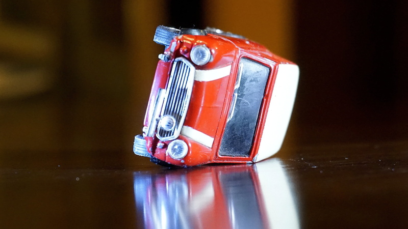reflection, cooper, car, watch, upset, toy car, close-up, single object, food and drink, indoors, vehicle, miniature, 2K, communication, toy, cast, die