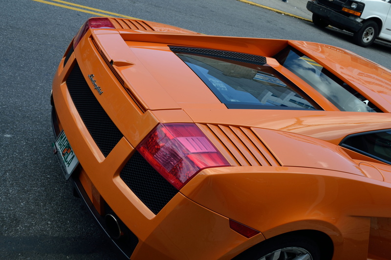 red, high angle view, mode of transportation, red orange, stationary, car, day, architecture, race car, style, license plate, fast car, new, glass, orange color