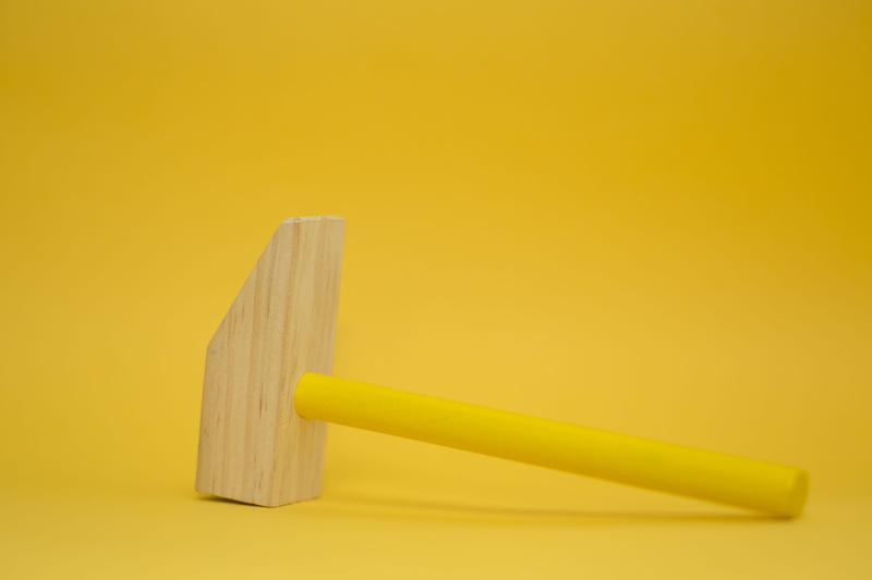 spaghetti, yellow, studio shot, challenge, close-up, no people, hammer, equipment, simplicity, two objects, toy, aggression, yellow background, copy space