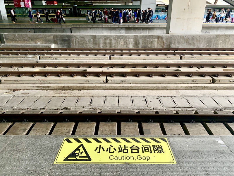 western script, sign, 4K, train track, group of people, transportation, information, non-western script, person, communication, apparel, urban, warning sign