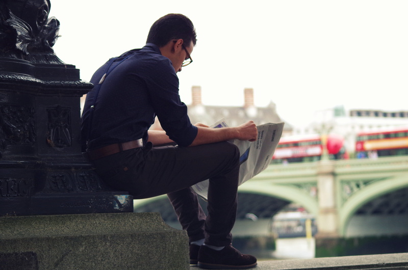 transportation, focus on foreground, built structure, man, casual clothing, urban, male, car, people, sitting, reading, day, leisure activity, architecture