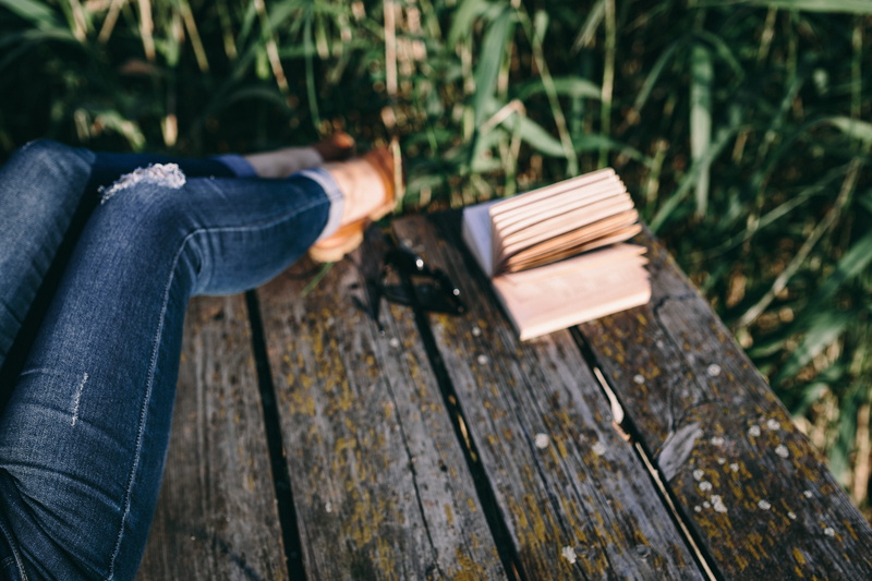 girl reading book, focus on foreground, adult, bench, book, evening, woman with book, man with book, lifestyles, wooden pier, wood - Material, real people