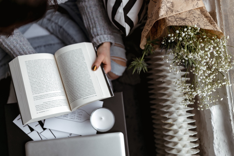 girl, jumper, leisure activity, sitting, 2K, education, real people, day, woman, publication, opened book, hand, reads, midsection, women, reader, time
