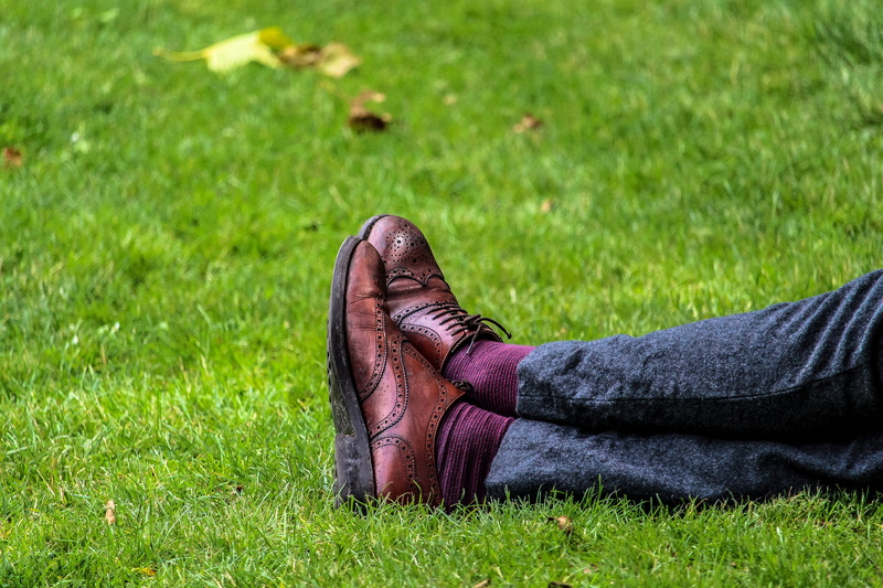 sitting, person, footwear, leather, sock, brown, day, outdoors, green color, real people, 5K, feet, pair, one person, wearing, body part, oxford shoes