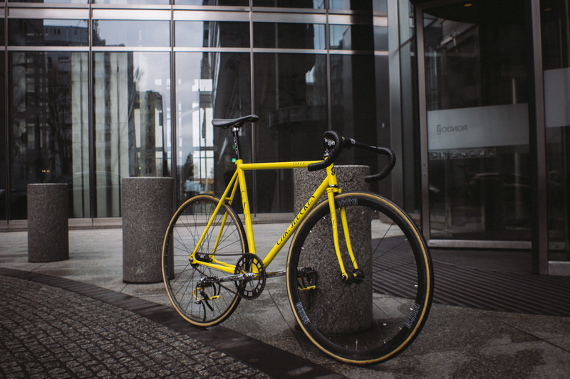 land vehicle, fixed gear, town, mode of transportation, glass, glass - material, transportation, city, yellow, poland, built structure, metropolis, bicycle