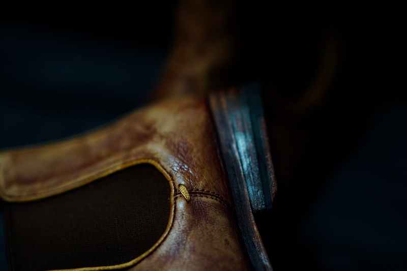 shoe, viola, fiddle, clothing, studio shot, team sport, single object, violin, leather, black background, suede, no people, boot, black, baseball glove