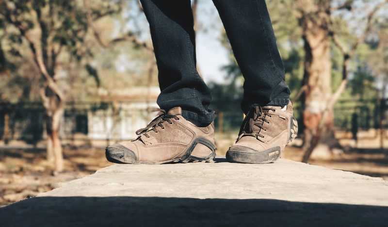 lace - fastener, real people, lifestyles, focus on foreground, close-up, human limb, men, woodland, outdoors, black color, one person, laces, tree, body part