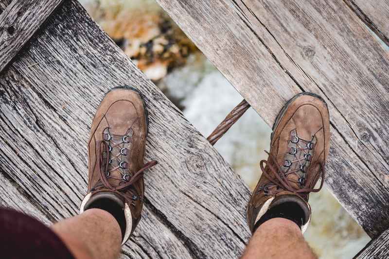 lifestyles, boot, real people, body part, text, personal perspective, wood, human body part, bokeh, focus on foreground, one person, high angle view, leisure activity