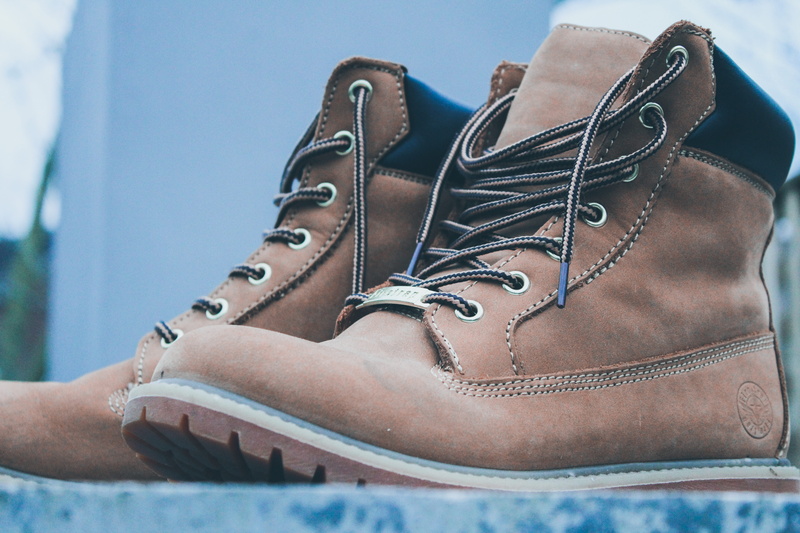 day, cowboy boot, blue, lifestyles, animal, wedge, human, black, boots, ski boot, focus on foreground, body part, pair, bag, person, fashion, hand, pedal