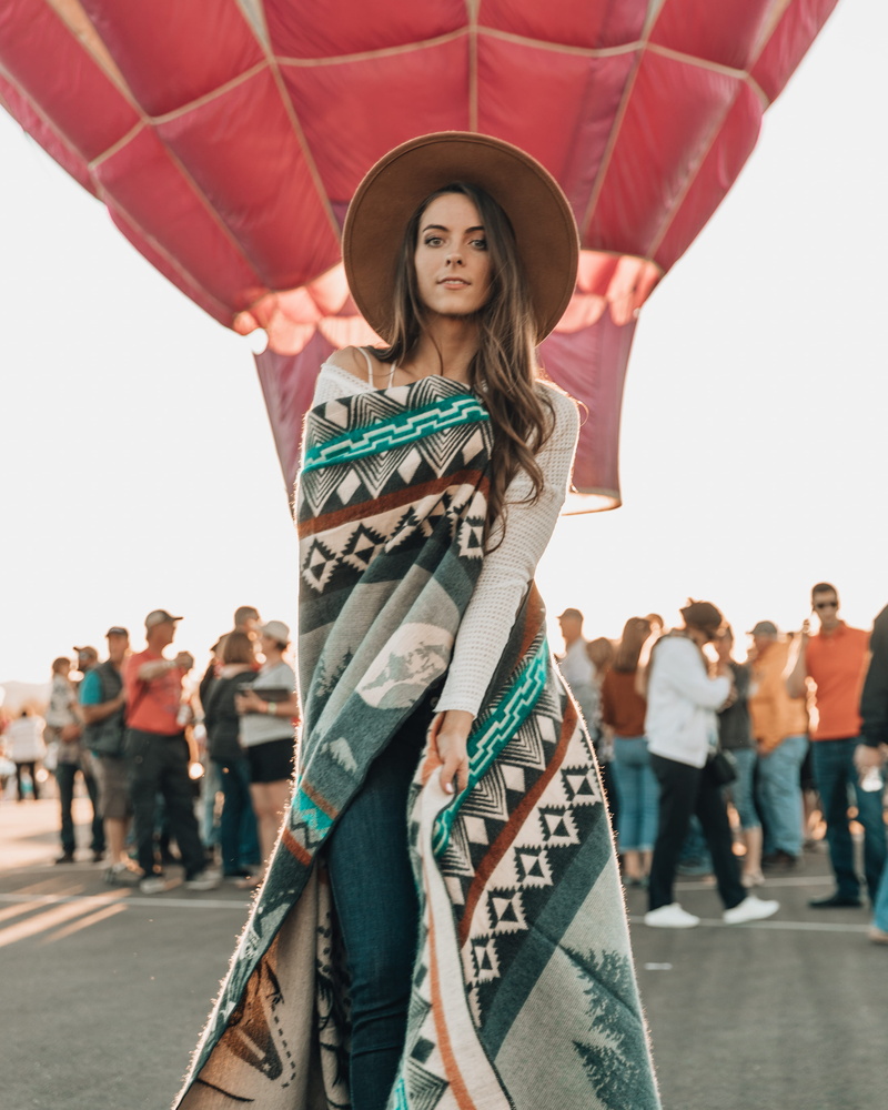 human, sky, focus on foreground, curved, festival, red, balloon, young women, smiling, crowd, person, portrait, incidental people, evening dress, aircraft