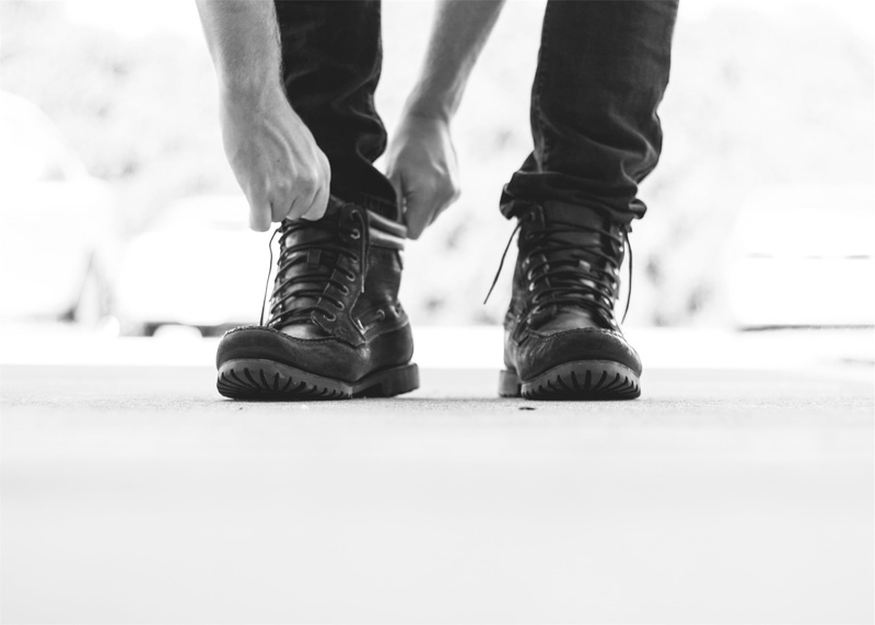 wearing, human limb, photo, day, unrecognizable person, cold temperature, limb, black, grayscale, motion, winter, shoe, outdoors, close-up, hands, boots