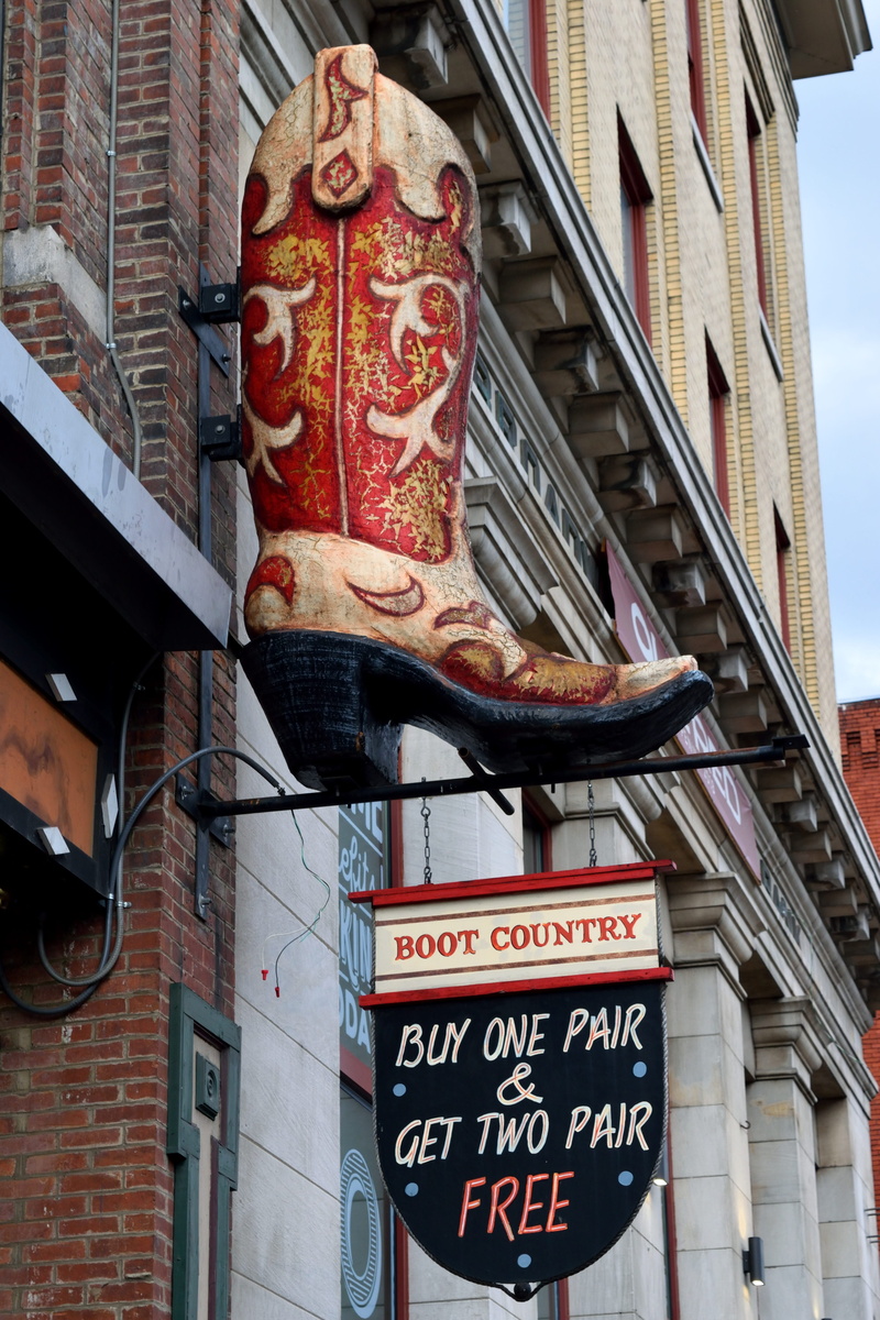 city, boots for sale, information, low angle view, icon, art and craft, shop, symbol, travel, lighting equipment, buy, no people, advertising, business